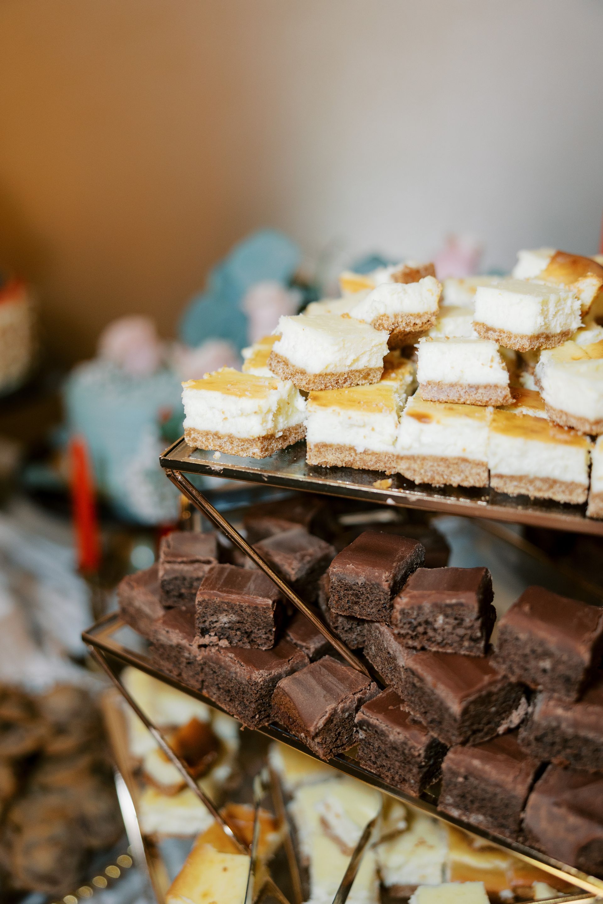 Dessert display: brownies and cheesecake squares on tiered glass platters.