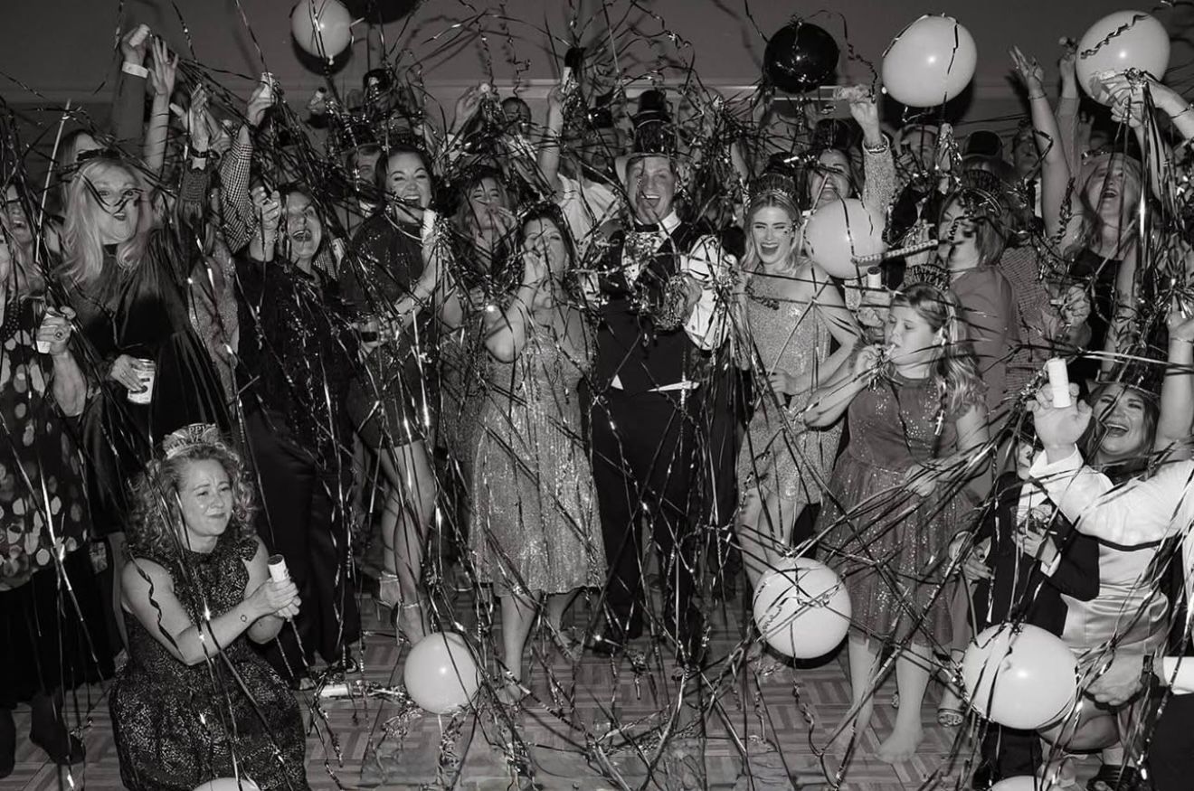 People celebrating with confetti and balloons.