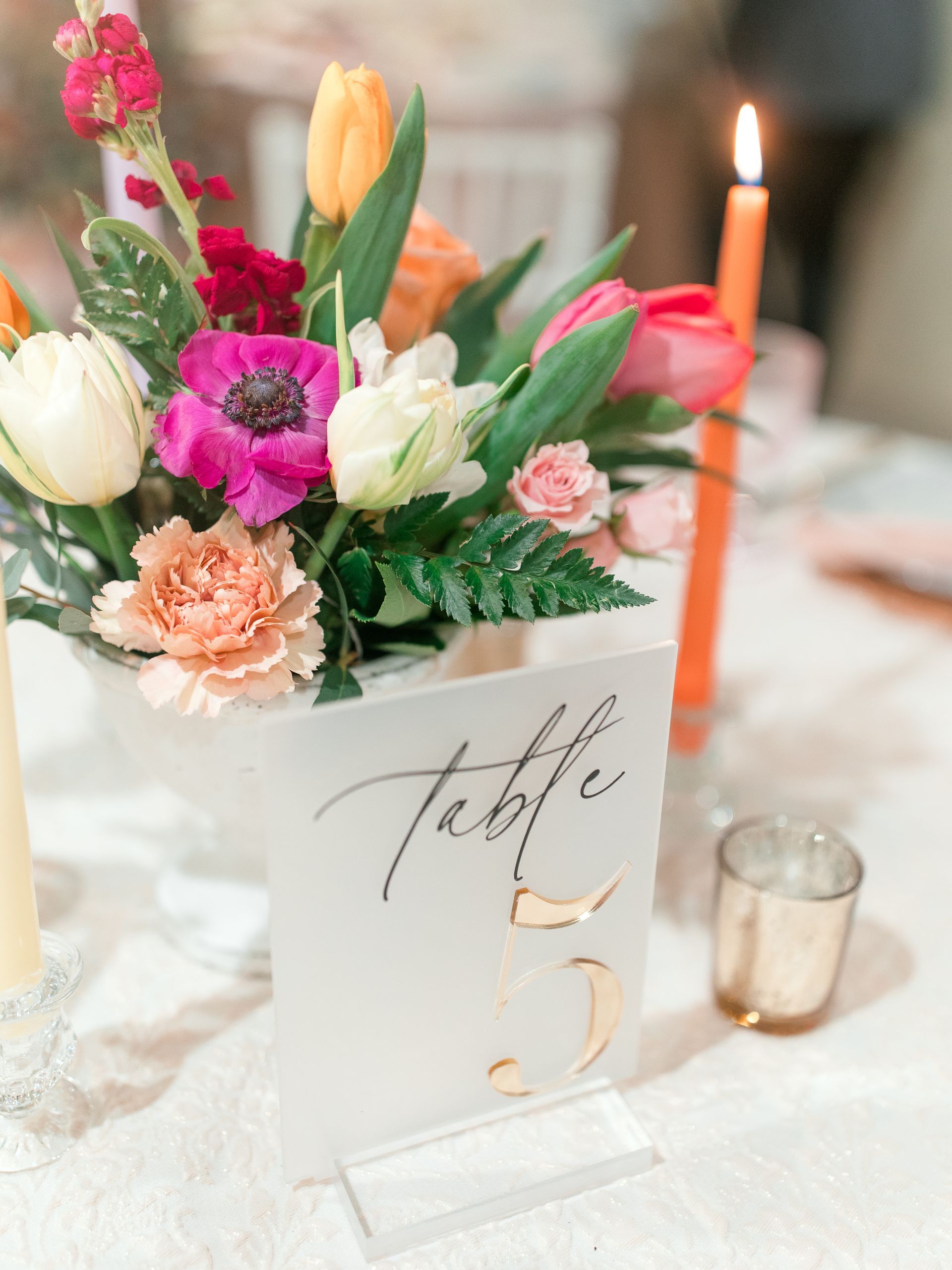 Table number 5 displayed with flowers and a candle.