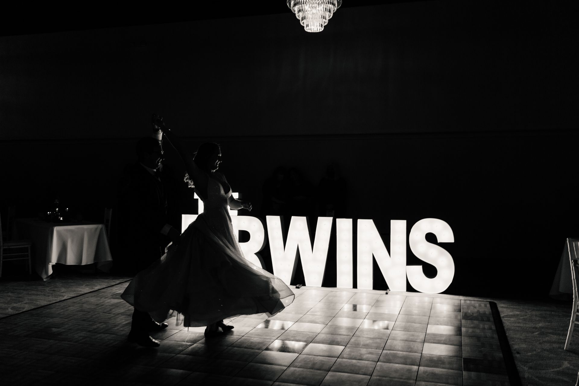 Couple dancing on a lit dance floor, large 