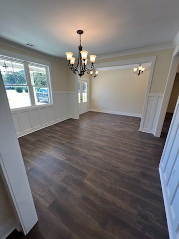 Modern living room with white sofa, glass coffee table, and sheer curtains.