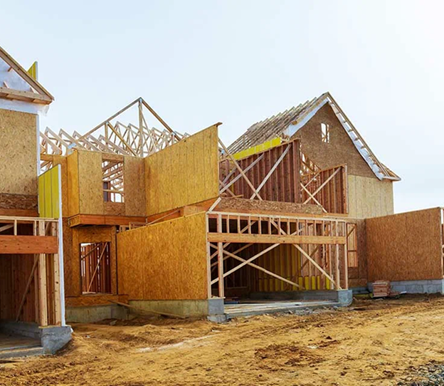 New houses under construction with exposed wooden frames and OSB sheathing.