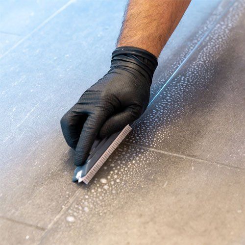 Close Up of Professional Cleaner Cleaning Grout with a Brush Blade — Adelaide, SA — Adelaide Carpet Care