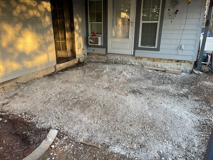 There is a lot of dirt on the ground in front of a house.