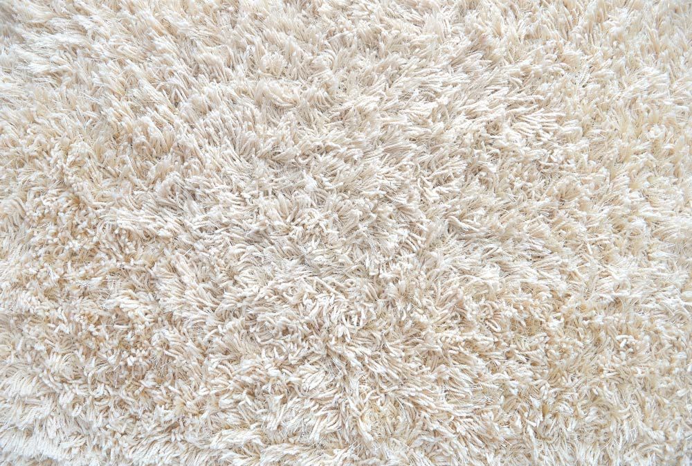A Close Up Of A White Fluffy Rug — Carpet in Googong, NSW