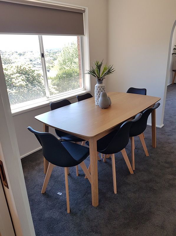 A Dining Room With Table, Chairs, And Black Carpet — Carpets & Flooring in Queanbeyan, NSW