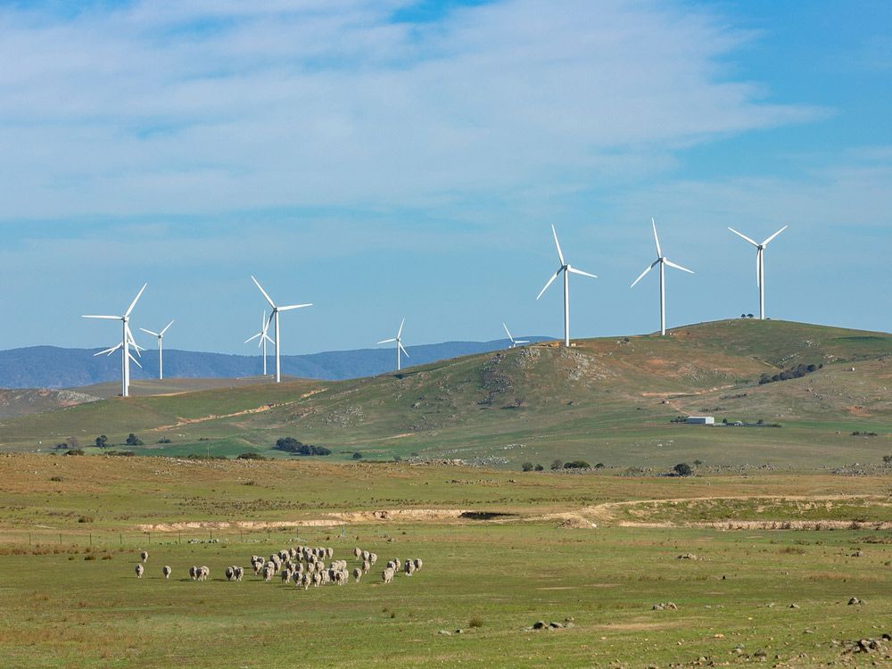 An Array Of Large Wind Turbines Moving On A Sunny Day Located Southeast Of Lake George And North Of Bungendore — Carpets & Flooring in Bungendore, NSW