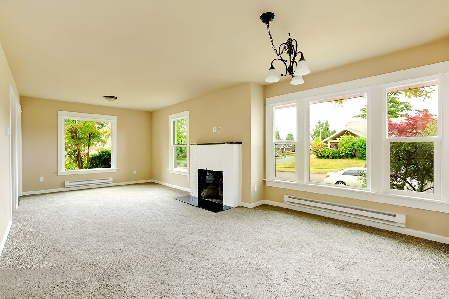 Empty Living Room with Beige Walls, Carpet, and Windows