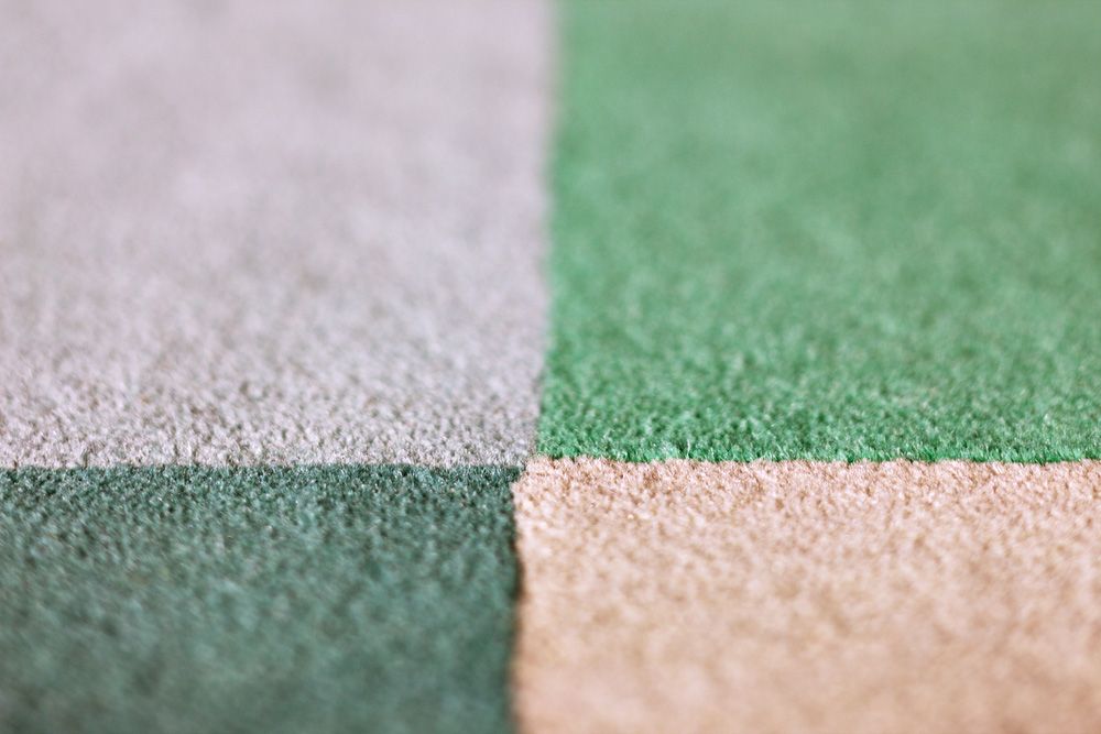 A Close Up Of A Green , White , And Brown Carpet — Carpets & Flooring in Queanbeyan, NSW