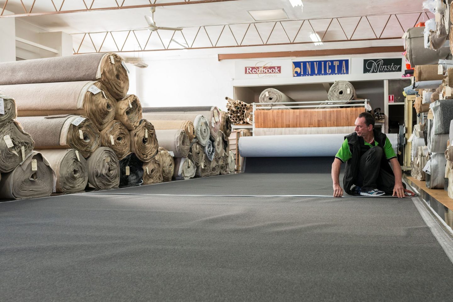 Carpet Store Aisle With Rolled Carpets — Queanbeyan Carpets in Queanbeyan, NSW