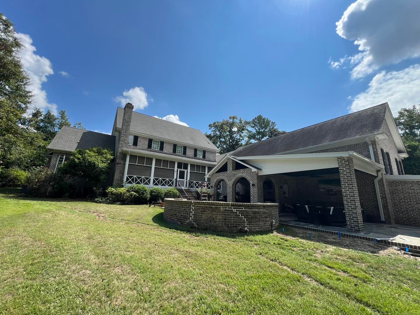 A large house with a large lawn in front of it.