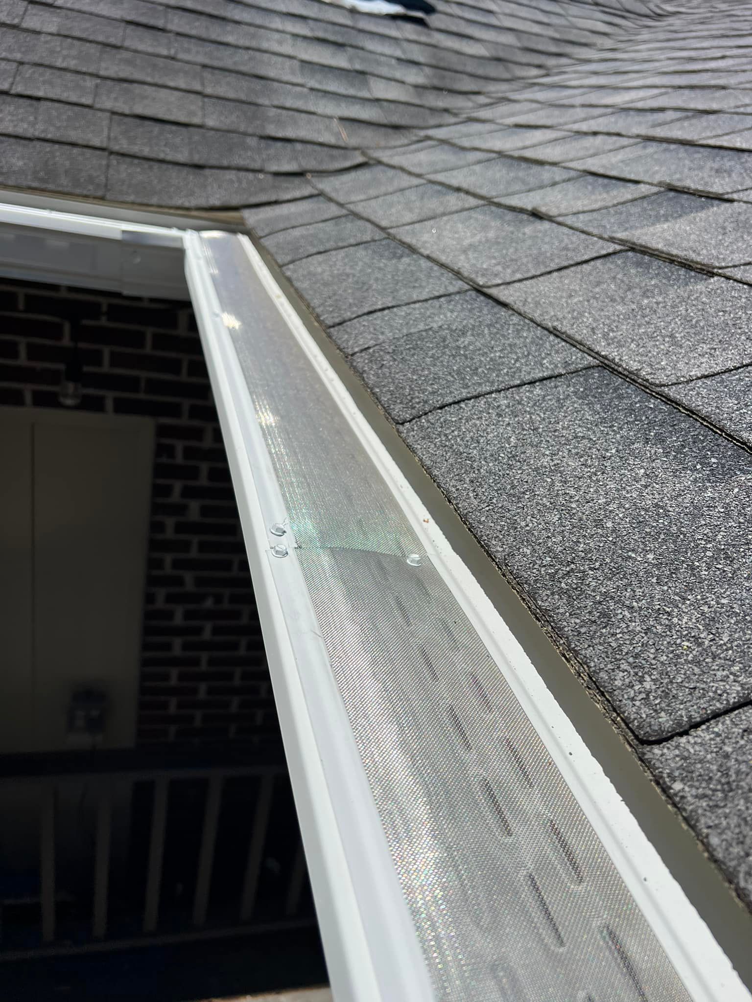 A large house with a lot of windows and a garage on a rainy day.