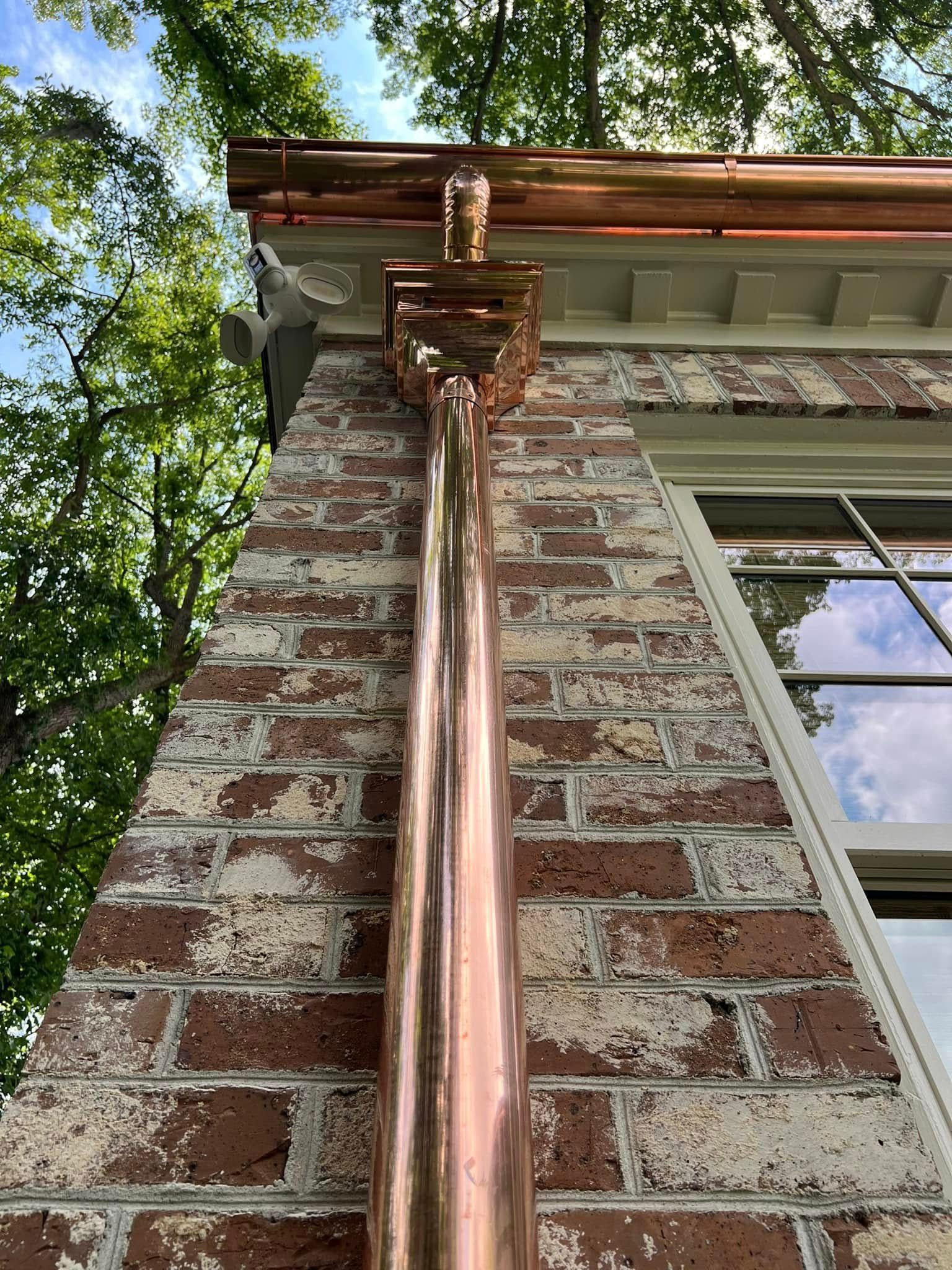 A large house with a lot of windows and a garage on a rainy day.