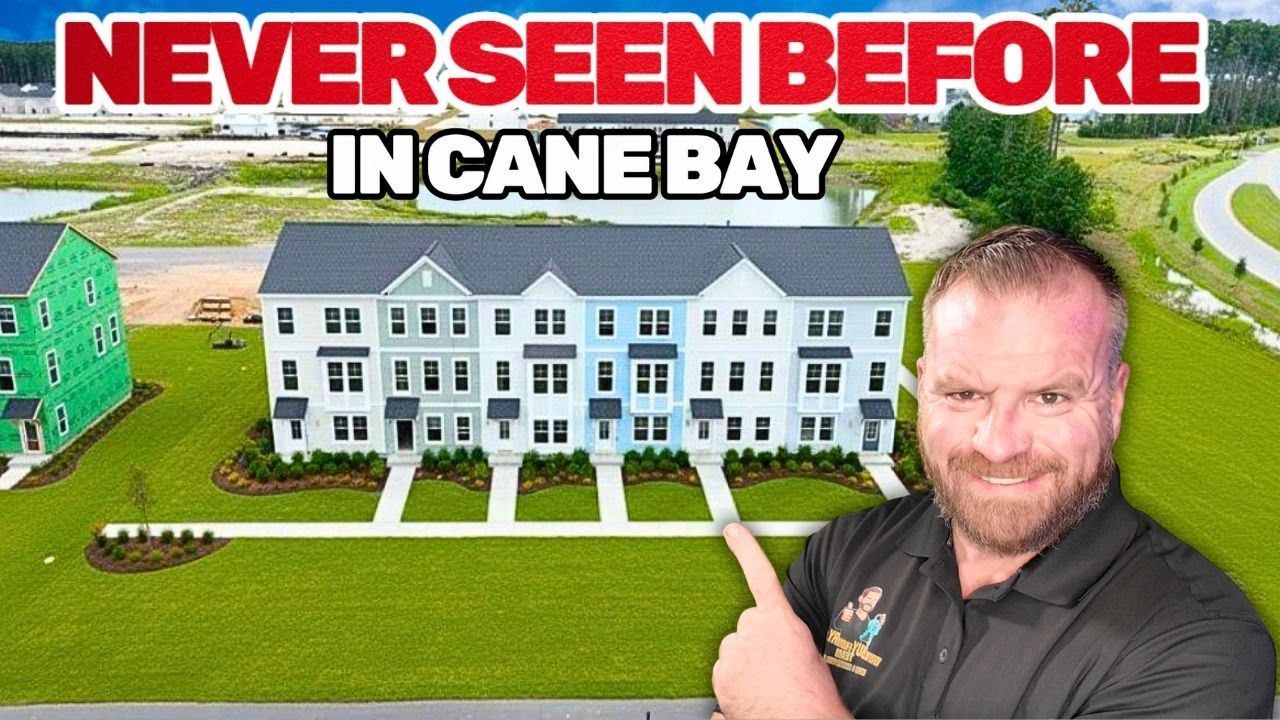 Man pointing at townhomes in Cane Bay, with