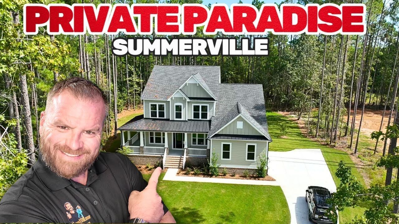 Man in front of a house, thumbs up. The house is gray with white trim, green lawn, and trees.