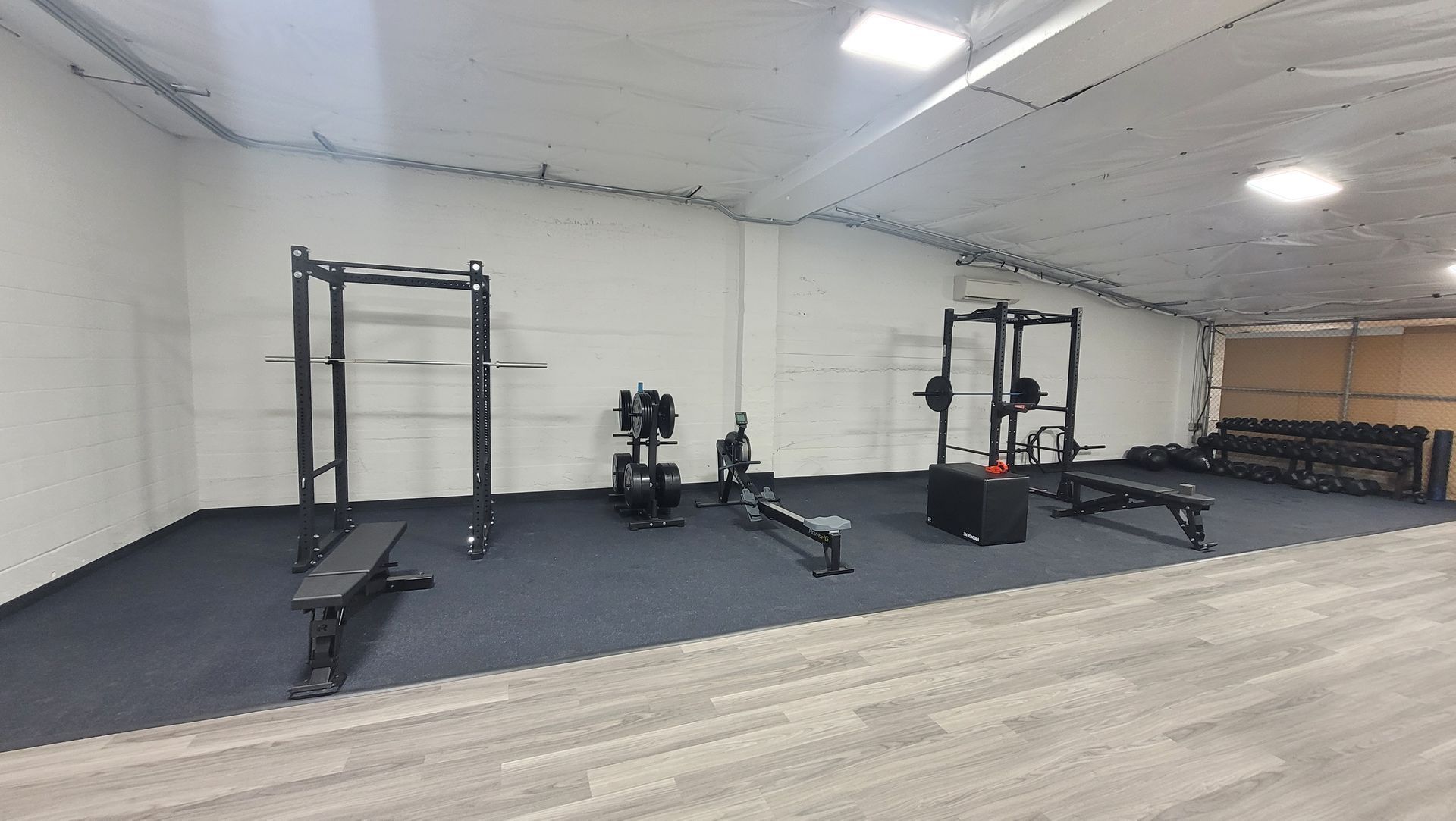 A gym with a lot of exercise equipment in it.