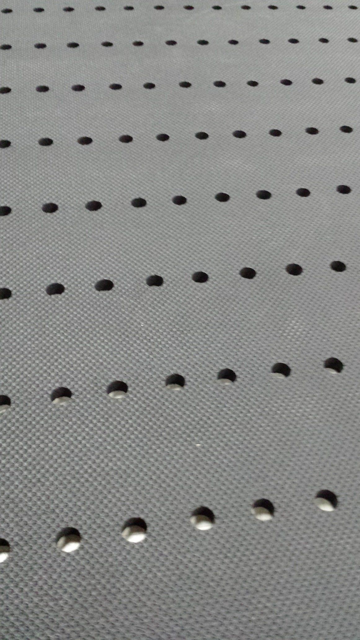 A close up of a piece of fabric with holes in it.