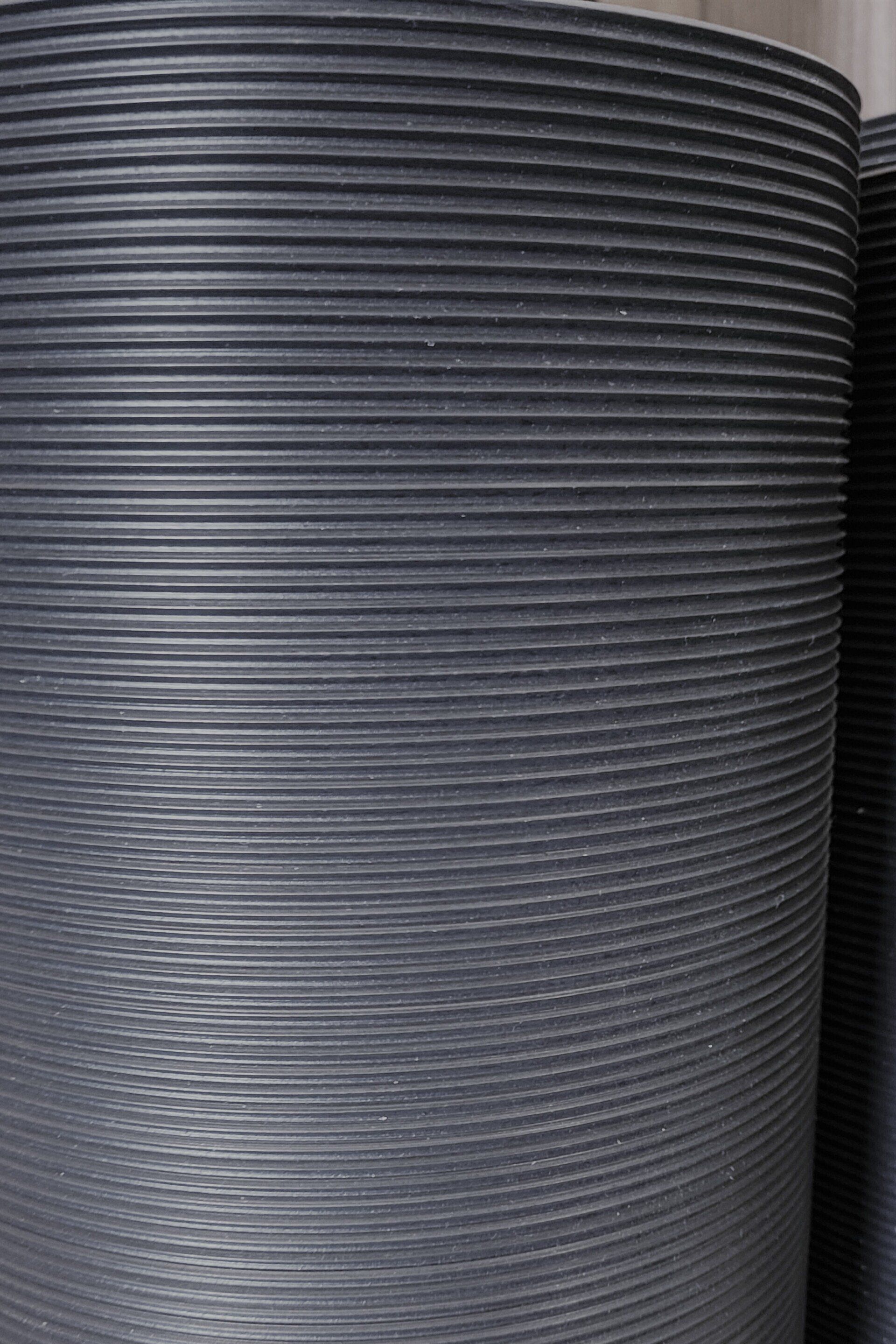 A close up of a gray rubber mat on a table.