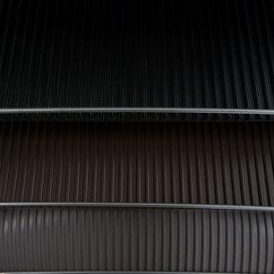 A close up of two different colored corrugated metal sheets stacked on top of each other.