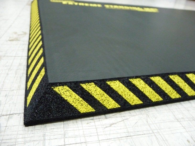 A black piece of paper with yellow stripes on it