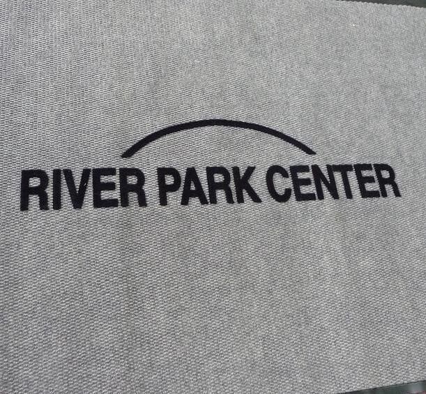 A river park center logo is embroidered on a door mat