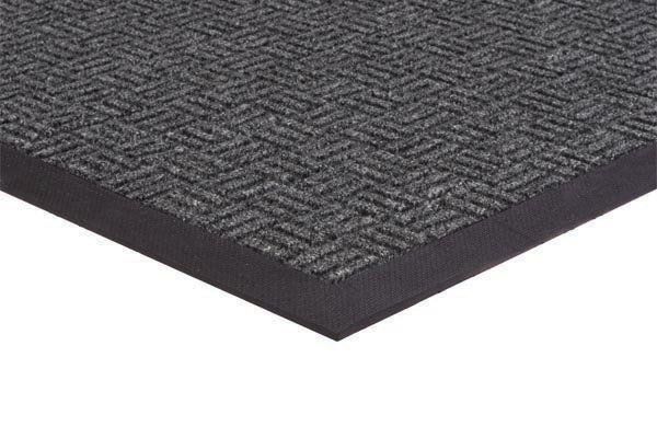 A close up of a black door mat on a white background.