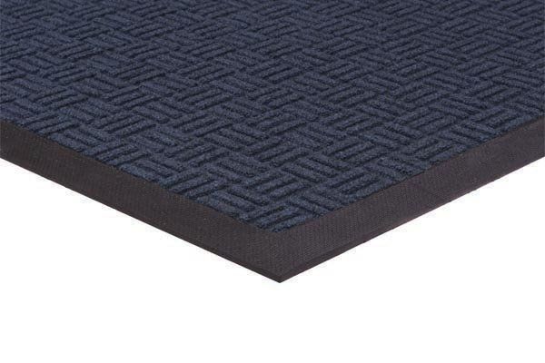 A black mat with a pattern on it is laying on a white surface.