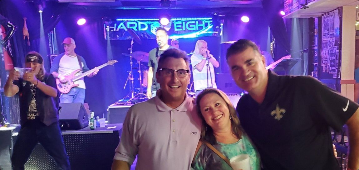 People pose with a band, 