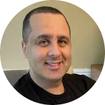 A man in a black shirt is smiling in a circle.