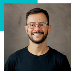 A man with a beard and glasses is smiling for the camera.