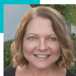 A woman with brown hair is smiling and wearing a black shirt