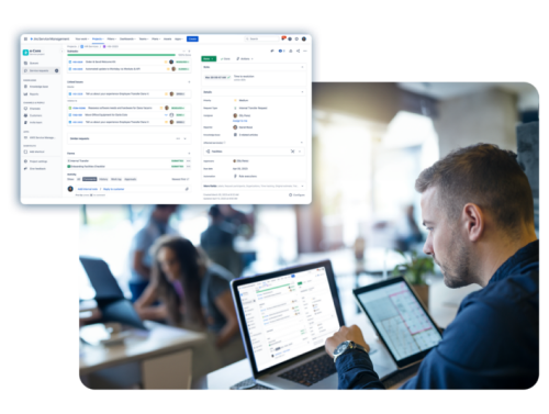 Um homem está sentado à mesa usando um laptop.