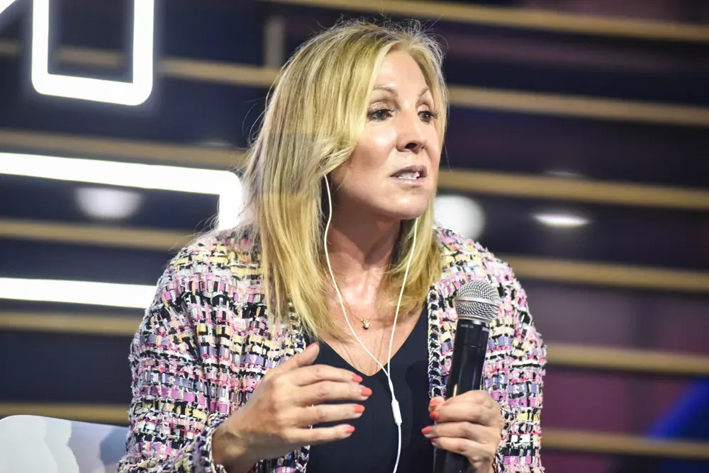 A woman is holding a microphone and talking into it.