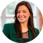 A woman in a green jacket is smiling in a circle.