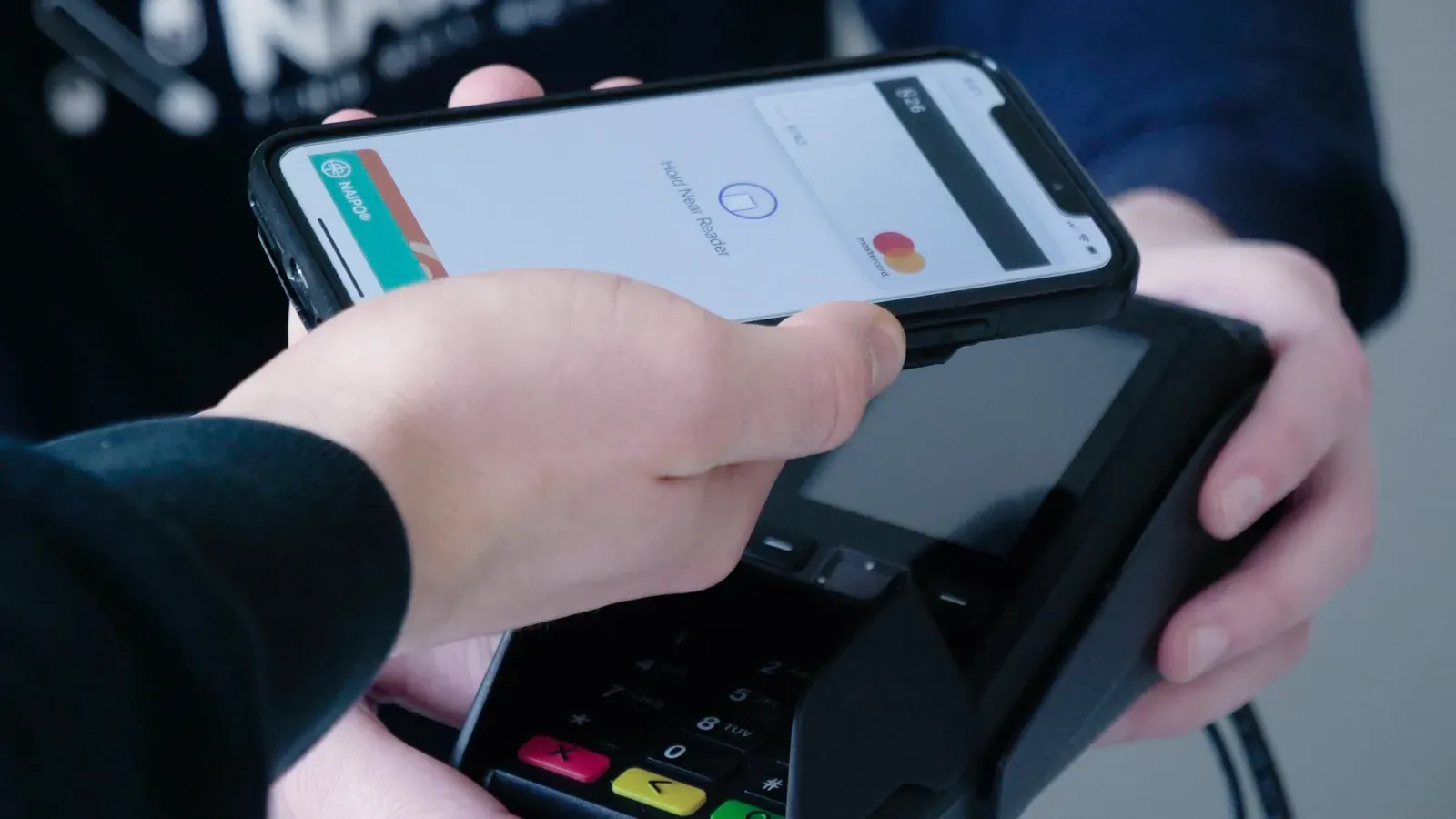 A person is using a smart phone to pay for something.