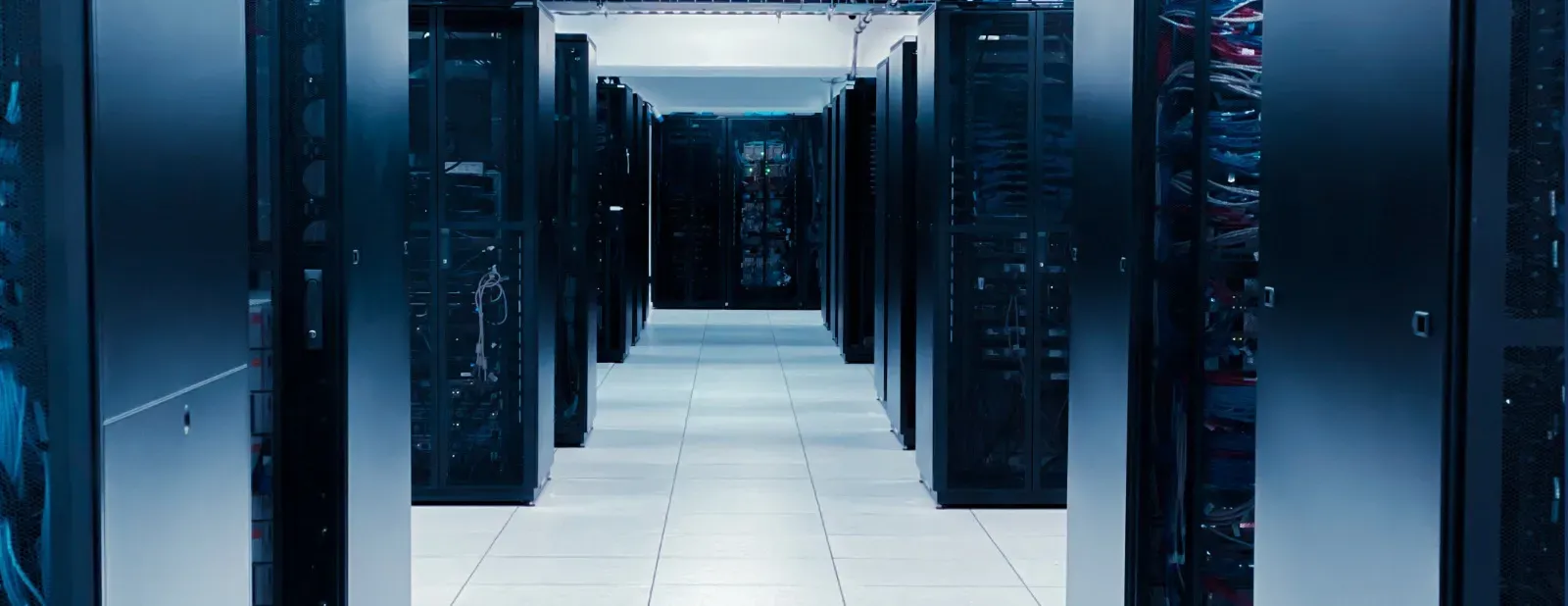 A hallway filled with rows of servers in a data center.