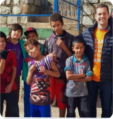 A group of young boys are posing for a picture with one boy wearing an american flag shirt
