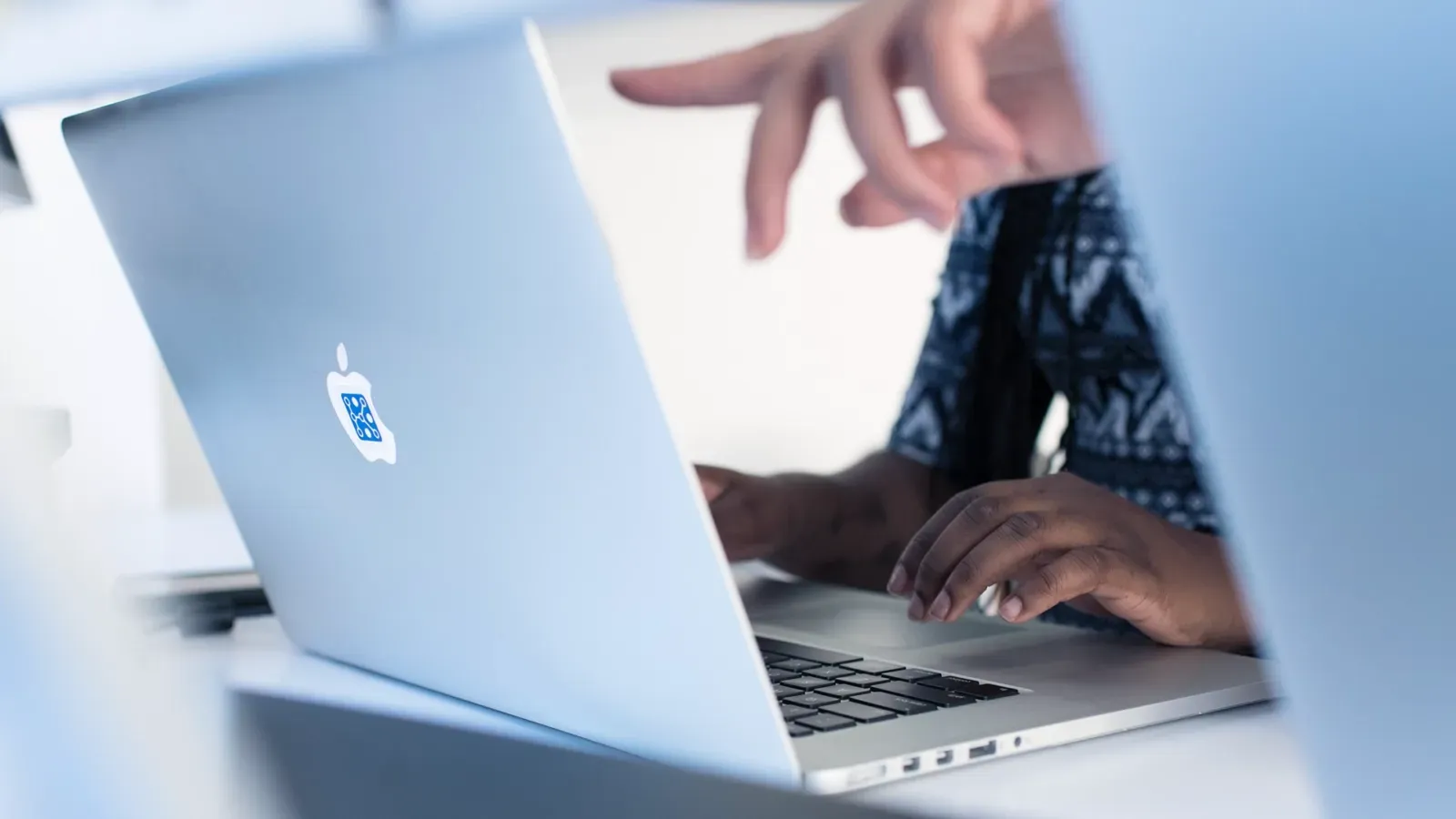 A person is typing on a laptop computer.
