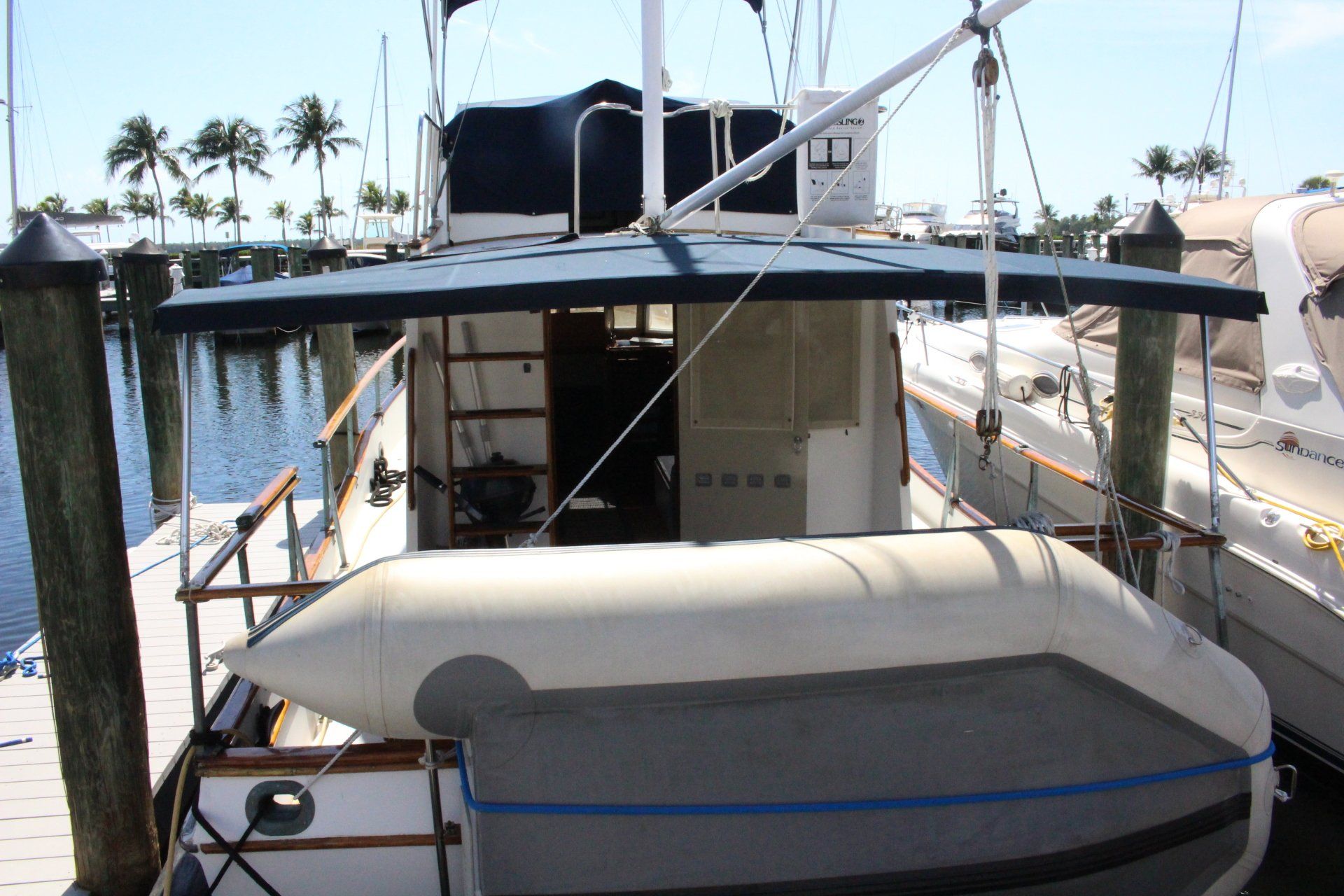 A boat is docked at a dock with a raft attached to it