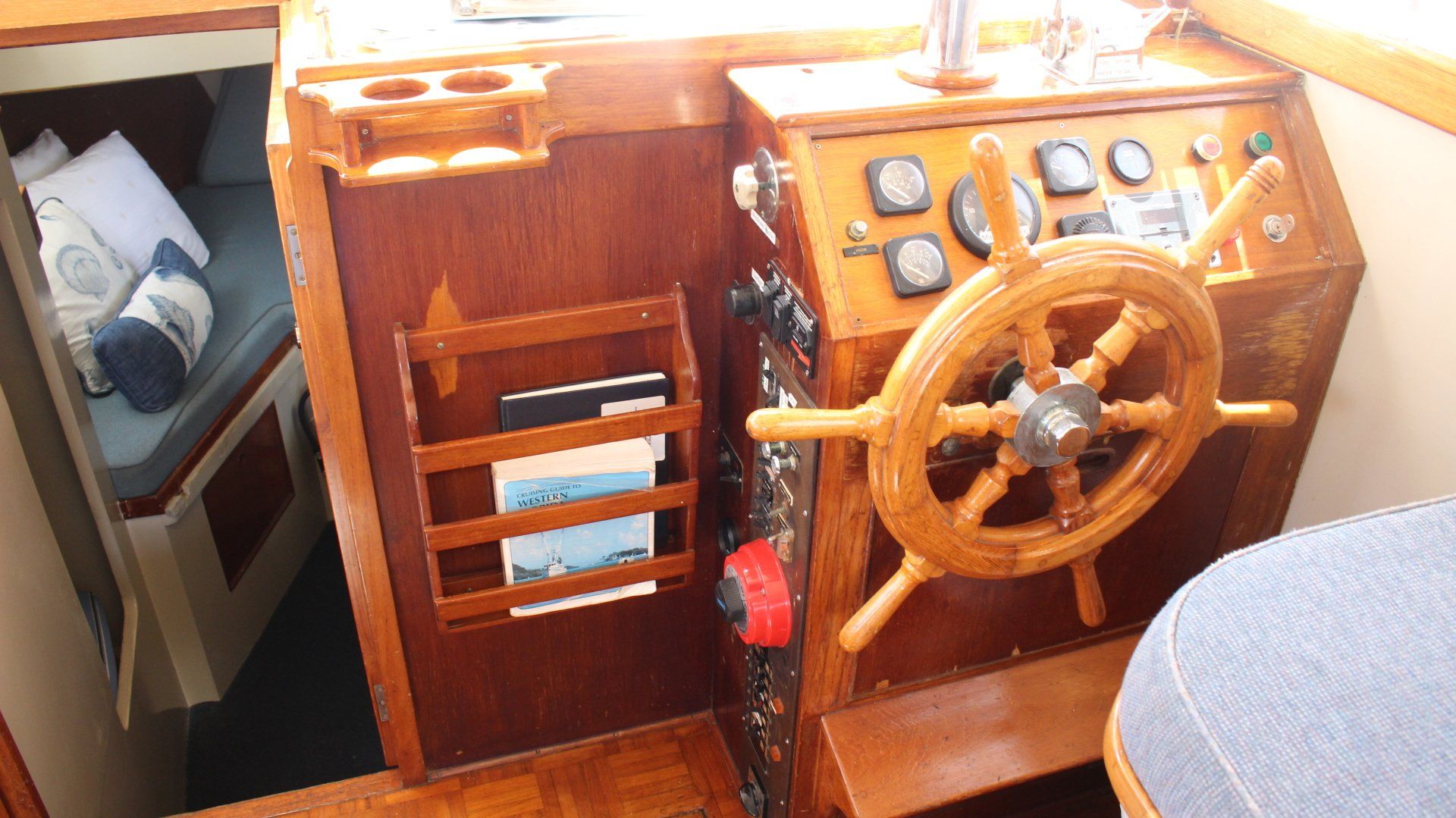 A wooden steering wheel is on a wooden boat