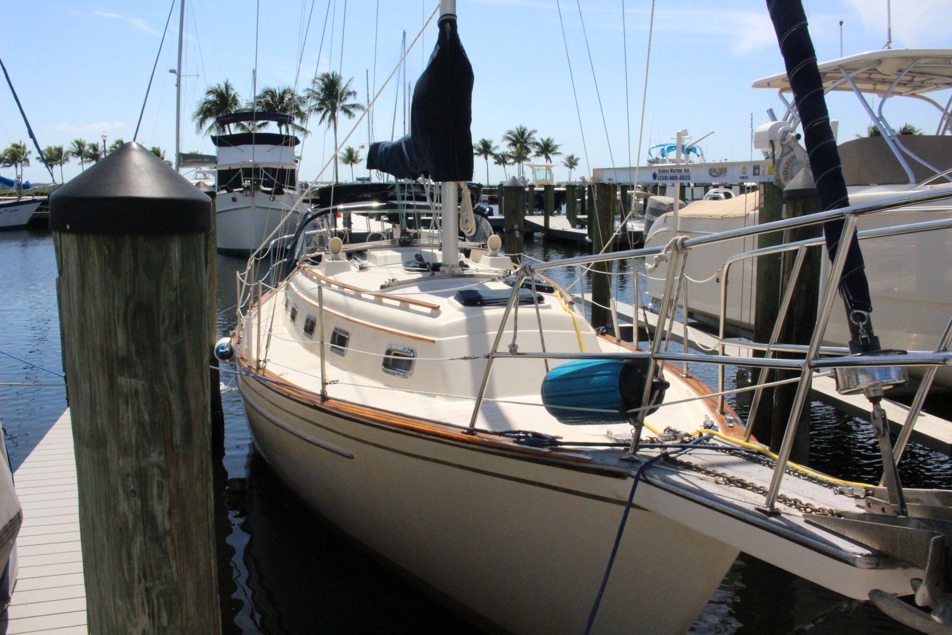 A sailboat is docked at a dock in a marina