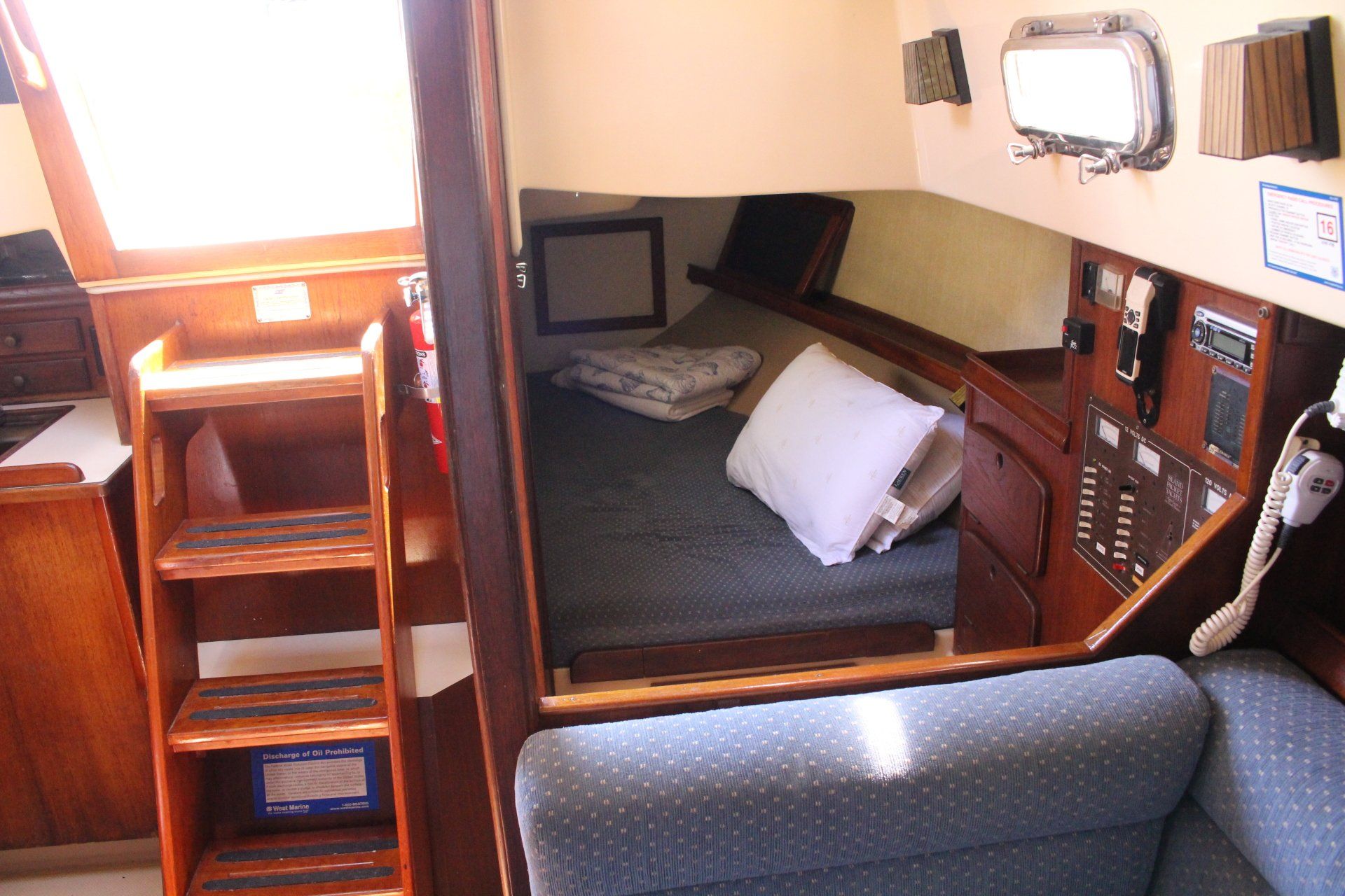 The inside of a boat with a bed and stairs
