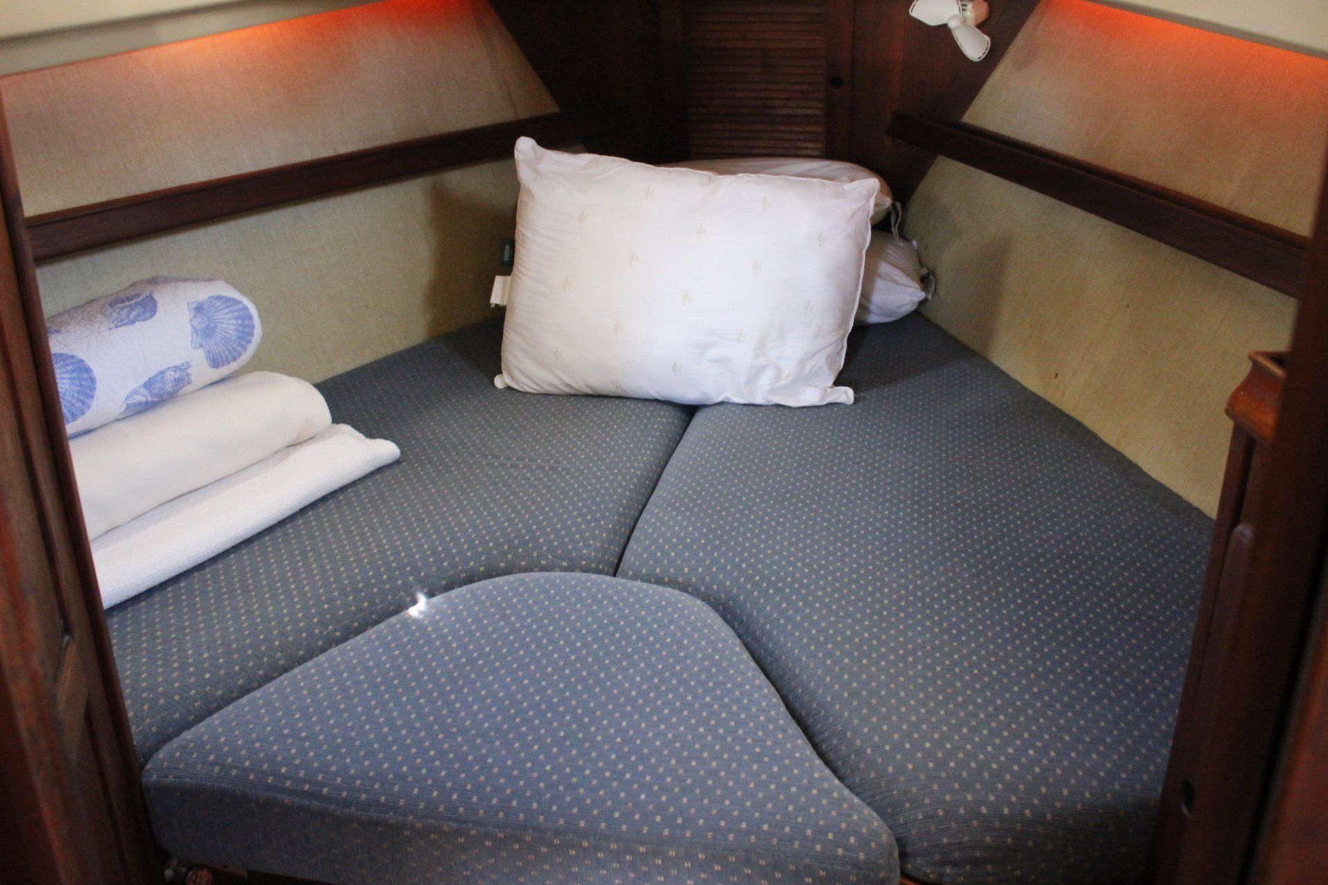 A bed on a boat with a pillow on it