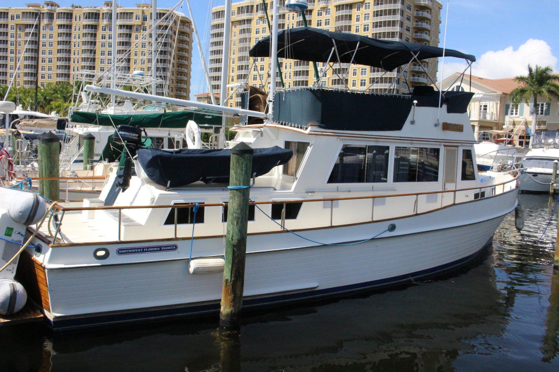 A boat is docked at a marina with a city in the background
