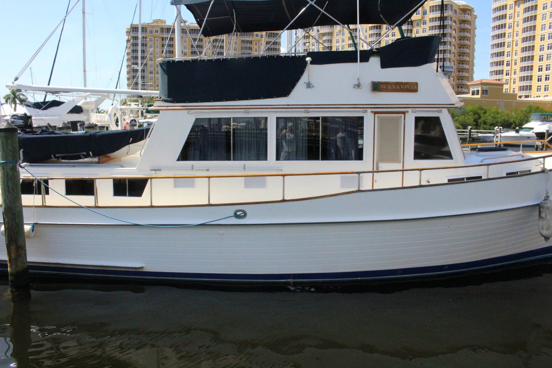 A white boat is docked at a dock and has the name triumph on the side