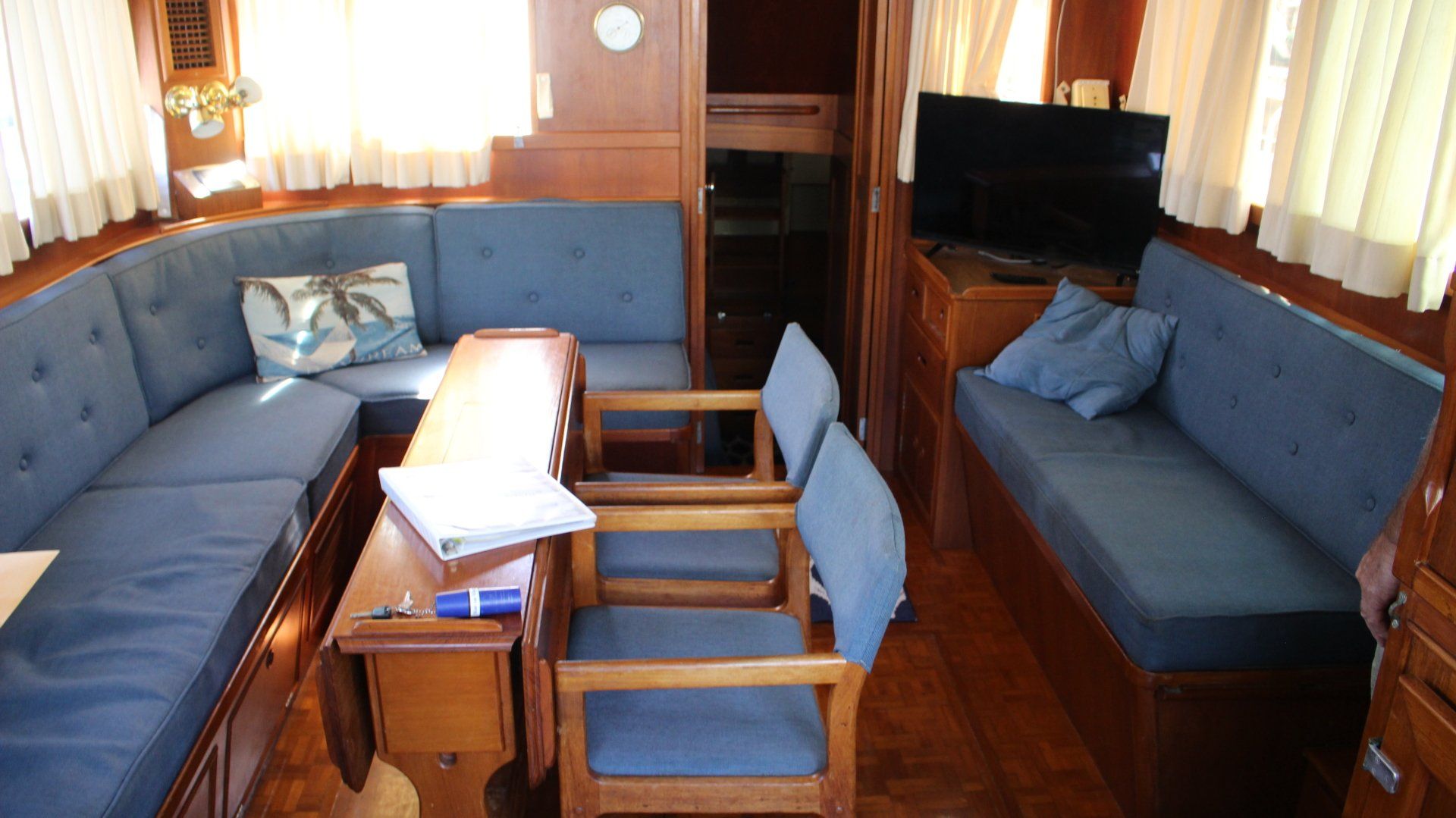 A living room with a couch , chairs , table and television.