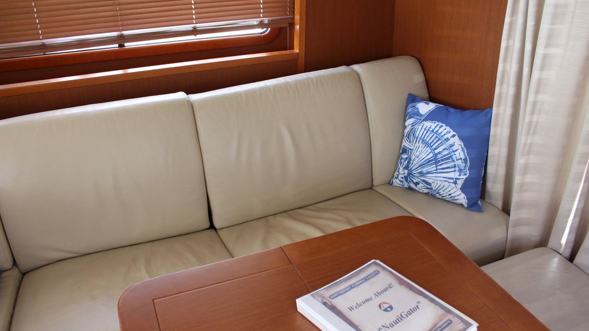 A living room with a couch and a table with a book on it