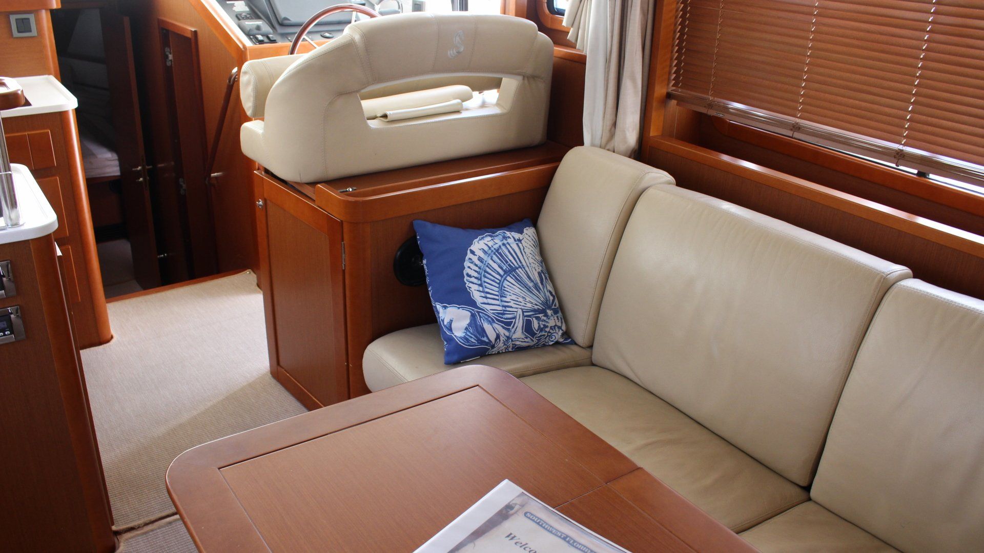A living room on a boat with a couch and a table.