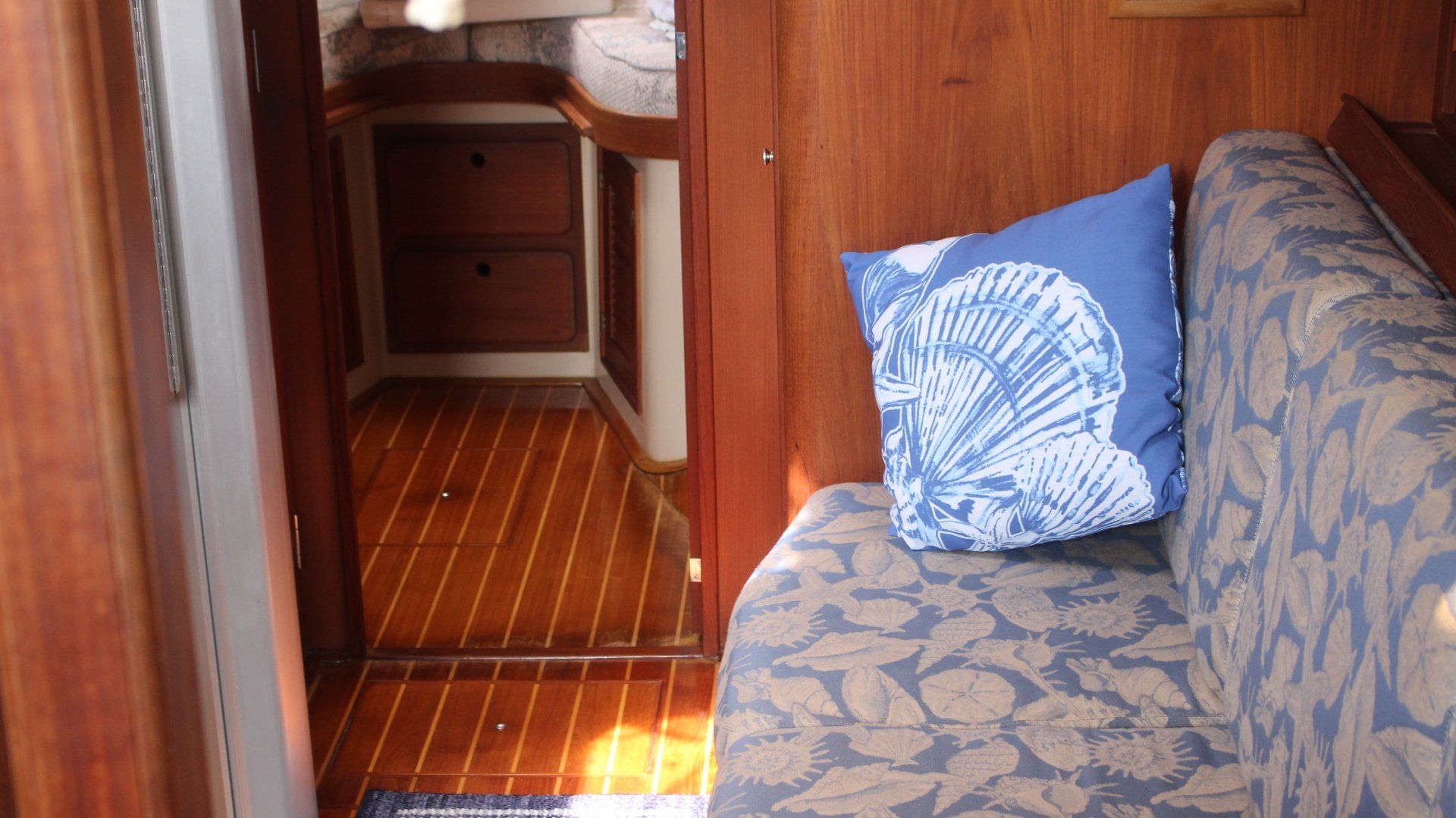 A couch with a blue pillow on it in a room