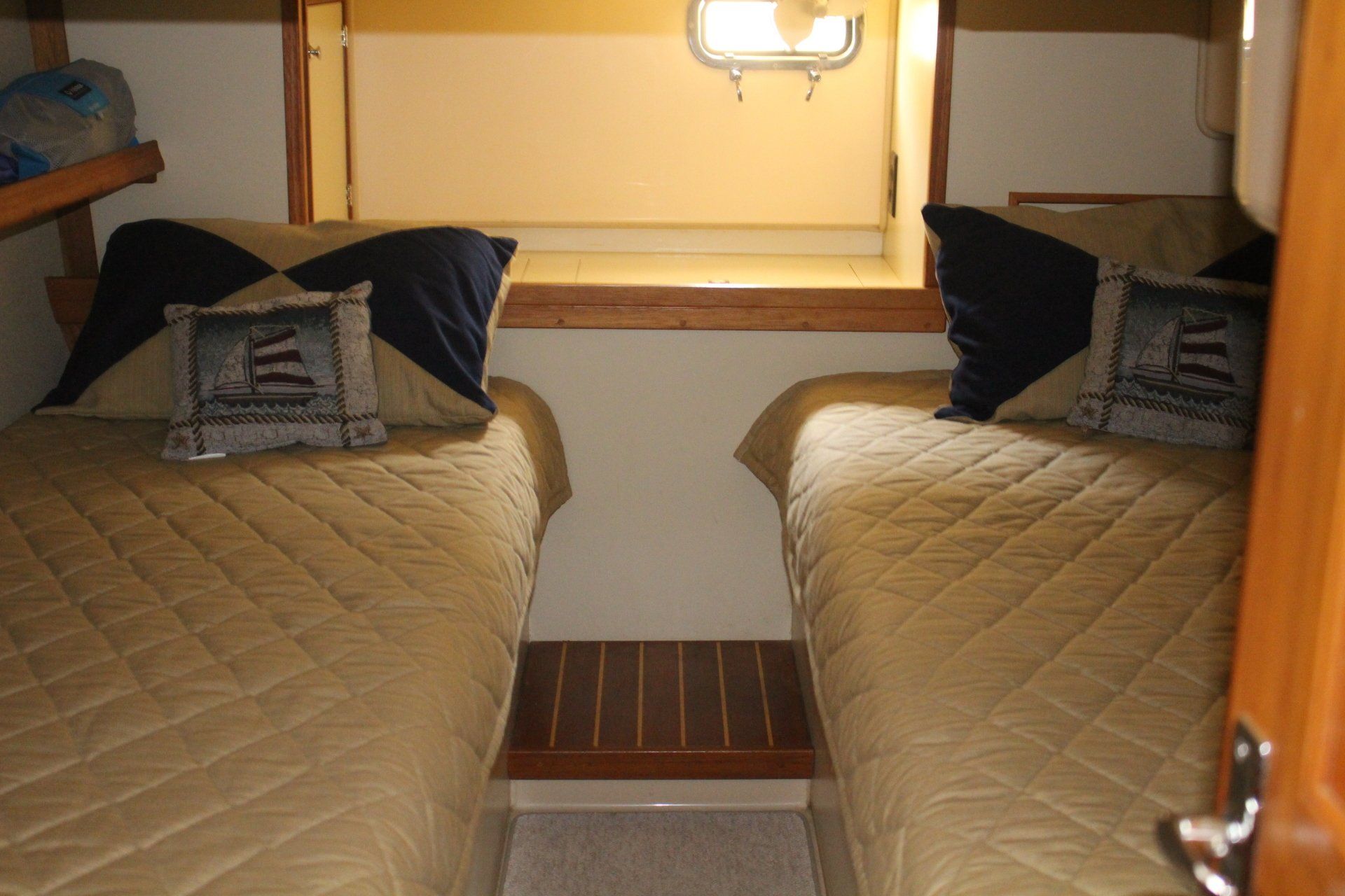 A bedroom with two twin beds and a window.